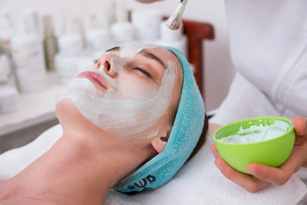 A woman undergoing a skincare procedure in a modern clinic.